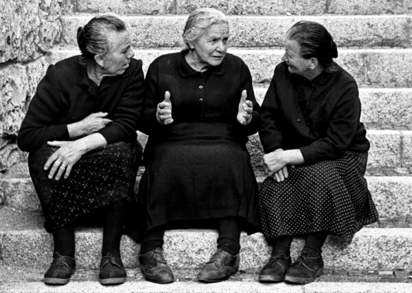 Foto di Nino Migliori di tre signore sedute su una scalinata.