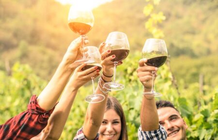 Friends,Hands,Toasting,Red,Wine,Glass,And,Having,Fun,Cheering